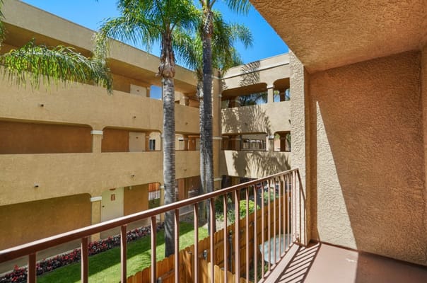 View from a balcony overlooking the courtyard with palm trees