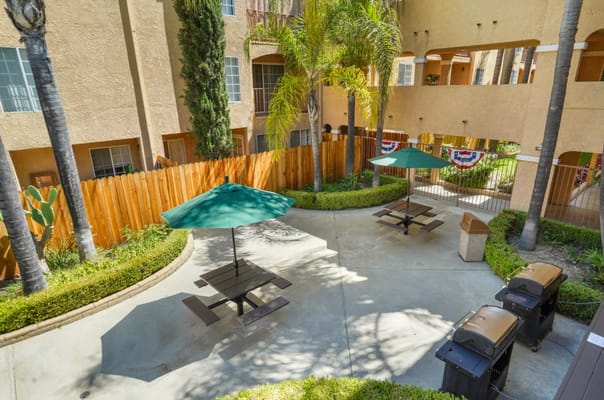 Outdoor seating area with umbrellas and greenery