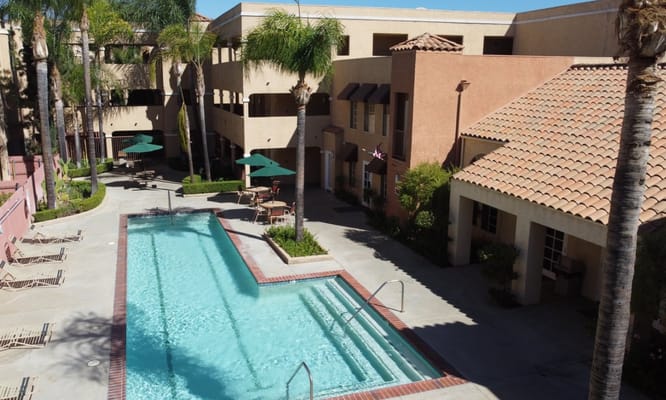 Aerial view of a swimming pool and courtyard area