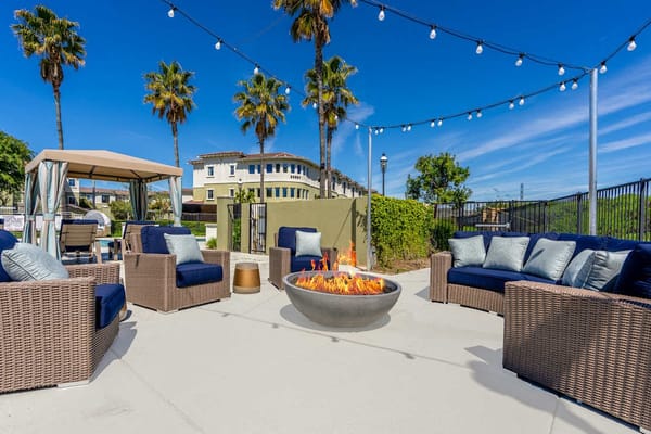 Outdoor lounge area with seating and fire pit