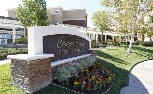 Signage of Canyon Country Senior Apartments in the garden