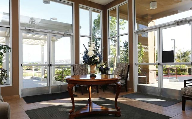 Bright lobby area with floral arrangement and seating