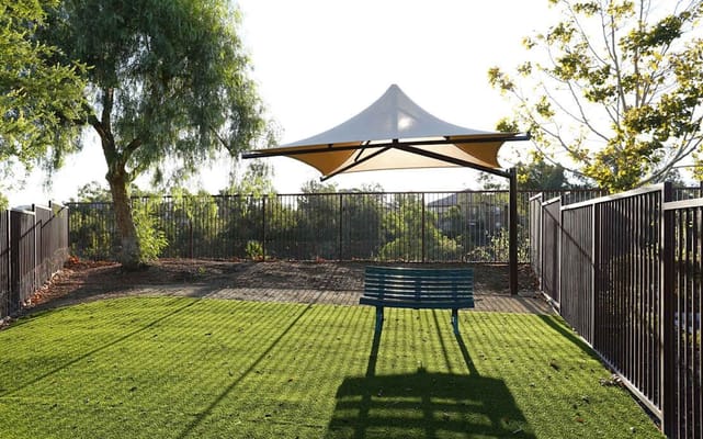 Outdoor seating area with shade and landscaping