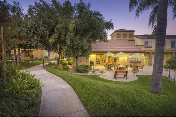 Outdoor seating area surrounded by gardens