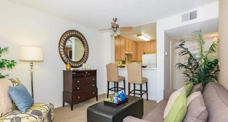 Cozy living room with a kitchen view in a senior unit