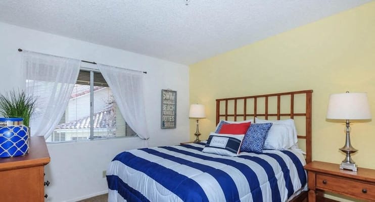 Cozy bedroom with a striped bed and warm decor