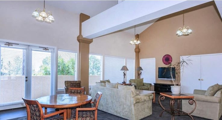 Bright common area with seating and a TV
