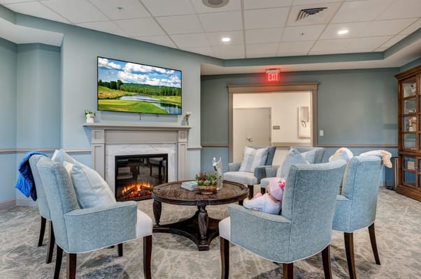 Comfortable seating area with a fireplace in a senior living facility
