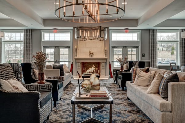 Cozy lounge area with modern furniture and decorative fireplace.