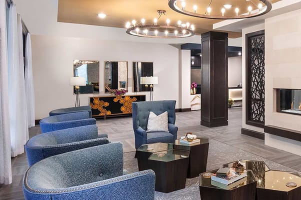 Modern lobby seating area with stylish chairs and decorative lighting.