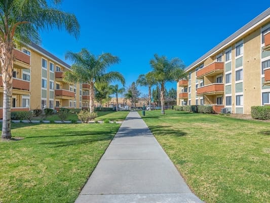 Pathway through landscaped outdoor space at The Orchards Apartments