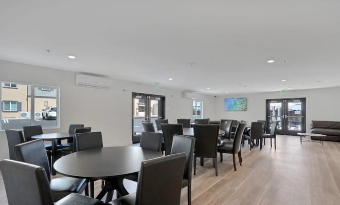 Common area with tables and chairs in a modern interior