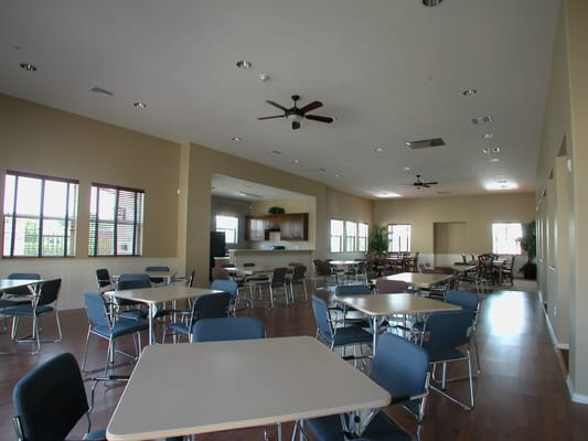 Bright and spacious common area with tables and chairs
