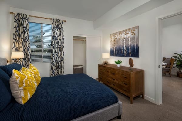 Cozy bedroom with a blue bedspread and decorative pillows
