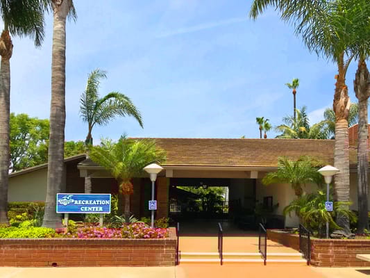 Entrance to the Recreation Center with palm trees and flowers