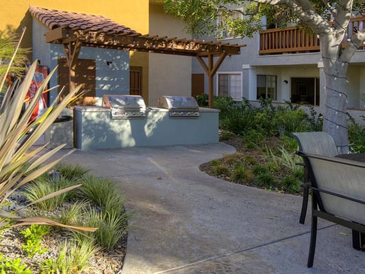 Outdoor grill area in a landscaped garden