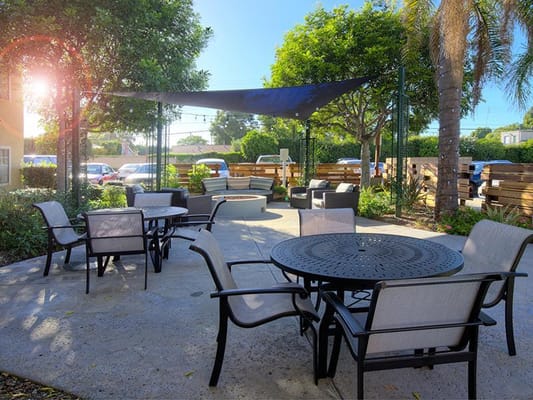Outdoor garden seating area with shading and greenery