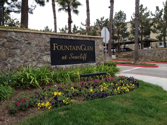 Exterior sign of FountainGlen at Seacliff with flowers