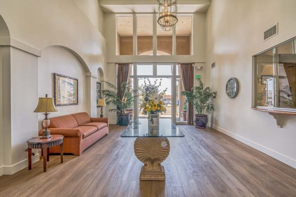 Bright and spacious lobby with a couch and decorative plants