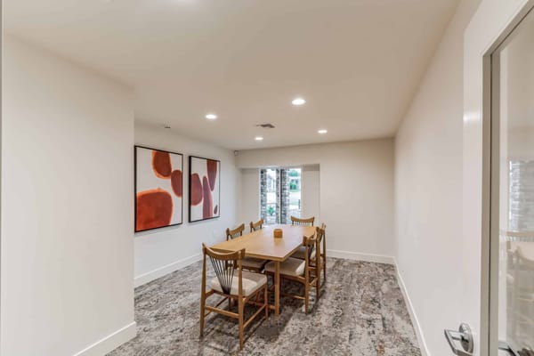 Dining area with table and chairs in a well-lit room