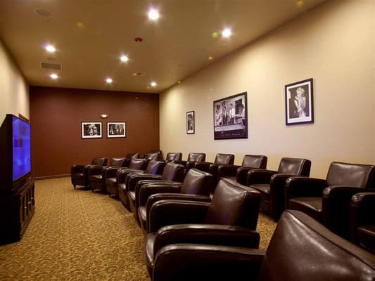 A cozy interior movie room with leather chairs