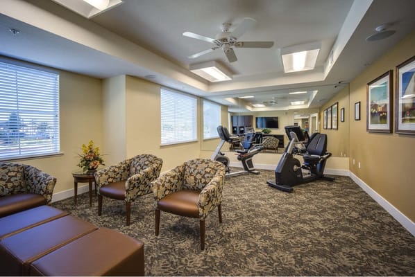 Interior gym area with exercise equipment and seating
