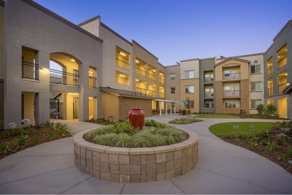 Outdoor courtyard with landscaped area and building facade