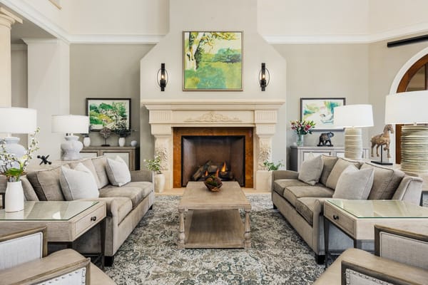 Comfortable living room with sofas, a fireplace, and decorative artwork