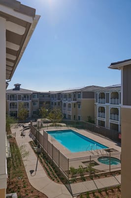Outdoor pool area with surrounding apartment buildings