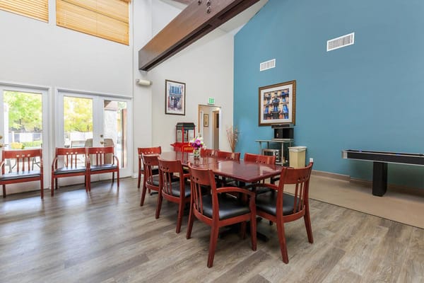 Bright common area with a large dining table and seating