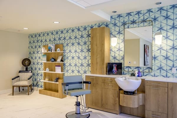 Salon area with styling chair and decorative wall