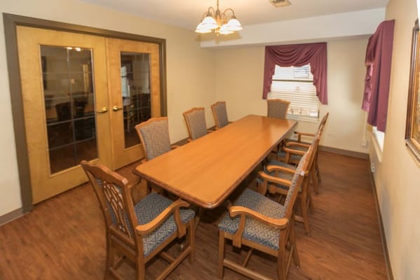 Bright dining room with a large wooden table and chairs