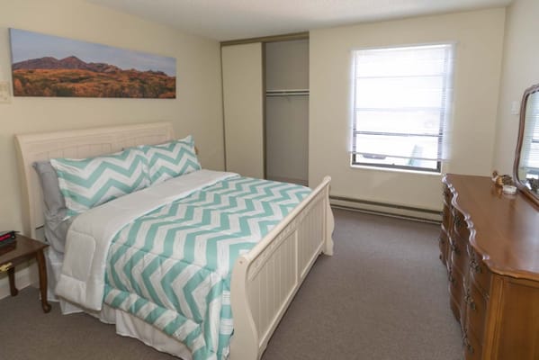 Cozy private resident room with bed and dresser