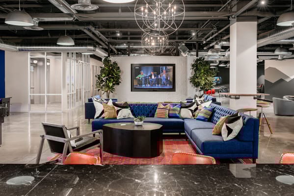 A modern common area with a blue sectional sofa