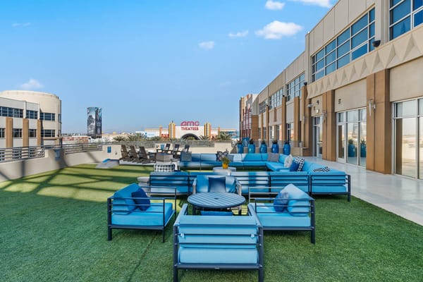 Outdoor seating area with blue furniture and green lawn