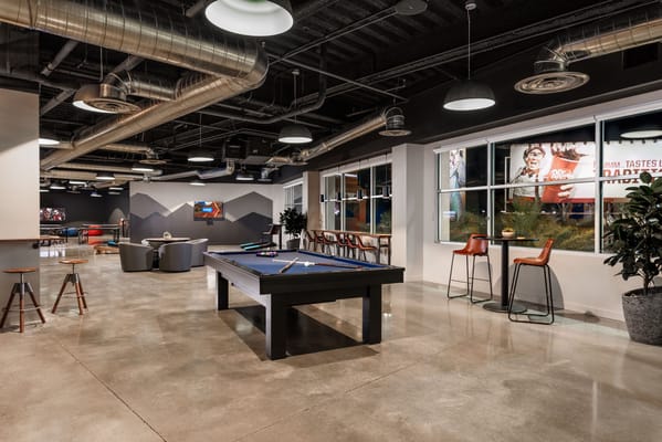 A common area with pool table and seating.