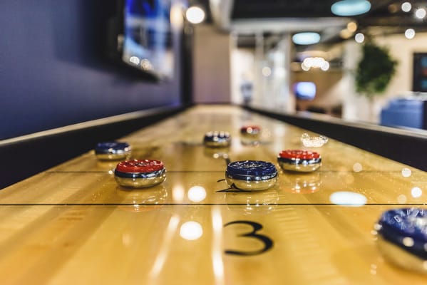 Close-up of a shuffleboard table in a common area
