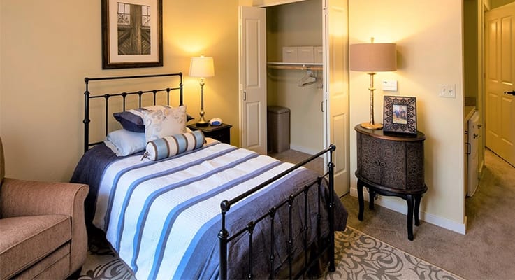 Cozy private resident room with a bed and lamp