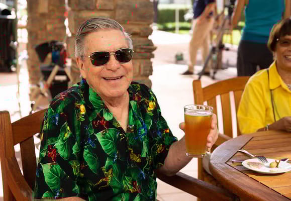 A resident enjoying a drink outdoors at St. Paul's Plaza