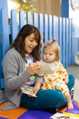 A caregiver reading with a young child