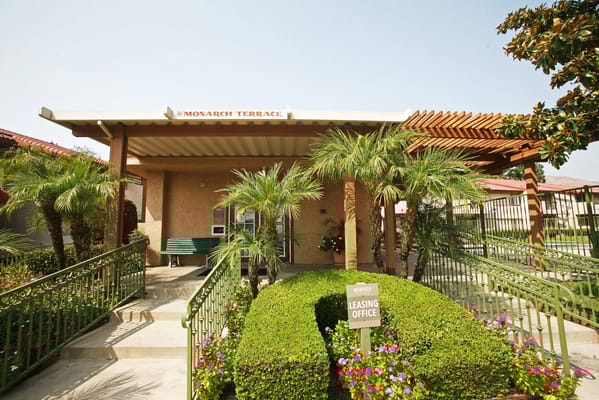 Exterior view of Monarch Terrace Apartment Homes with landscaping