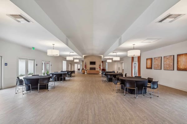 Bright dining room with tables and chairs arranged