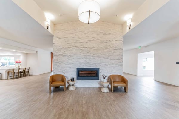 Bright common area with modern seating and a fireplace