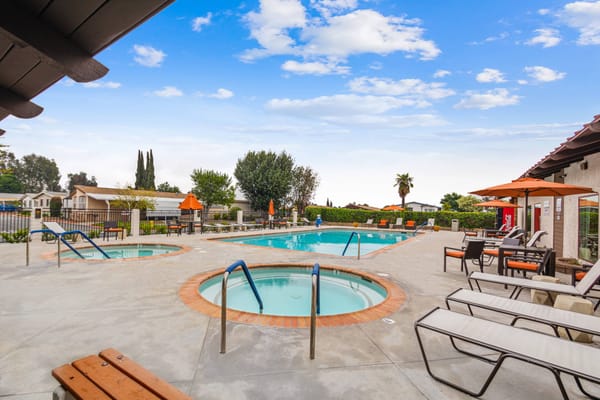 Outdoor pool area with residents enjoying the sun