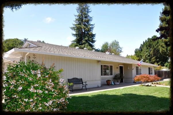 Exterior view of a facility with garden and seating area