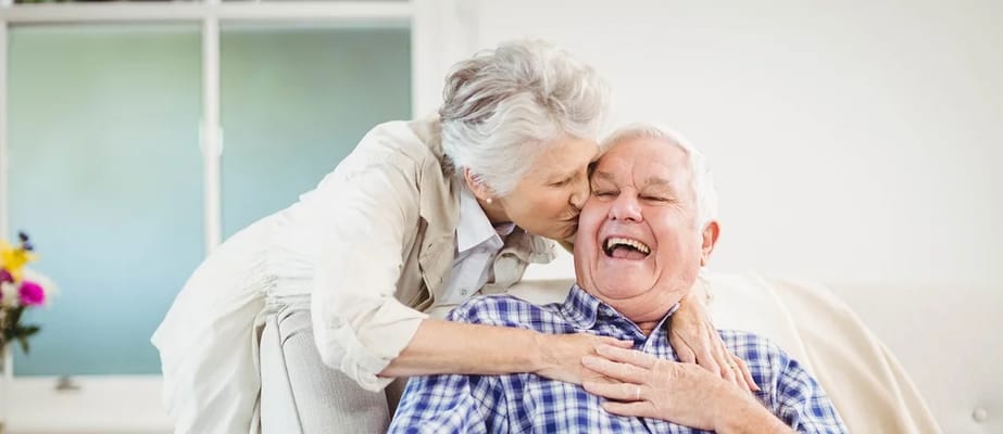 A joyful interaction between a senior couple indoors