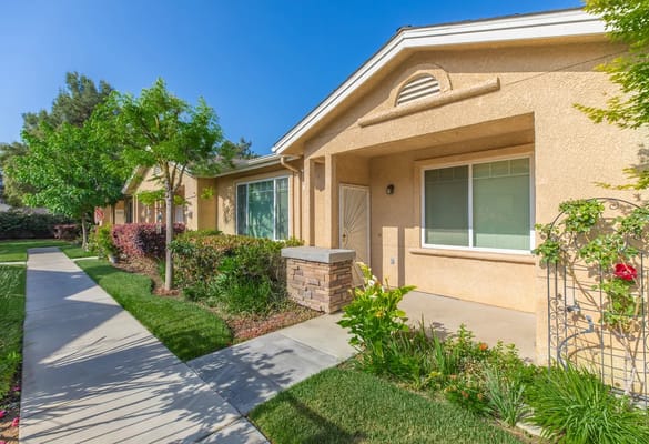 Exterior view of senior apartments with landscaped walkway