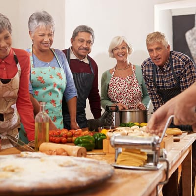Residents cooking together in a cheerful kitchen