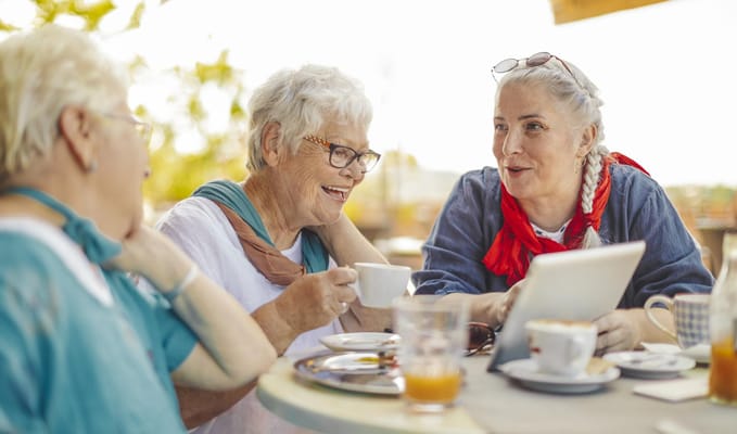 Seniors enjoying coffee and conversation outdoors