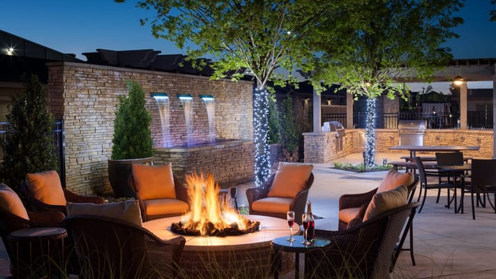 Outdoor fire pit area with seating and landscaping